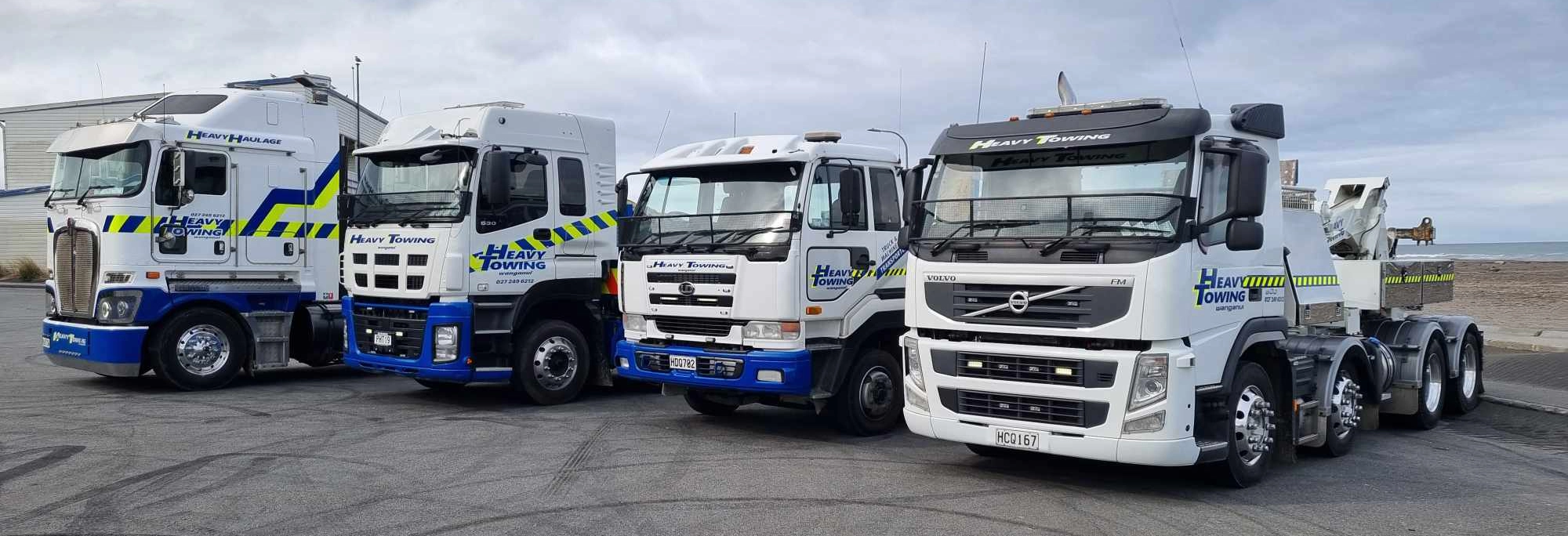 Four Heavy Towing Wanganui tow trucks and recovery units lined up side by side