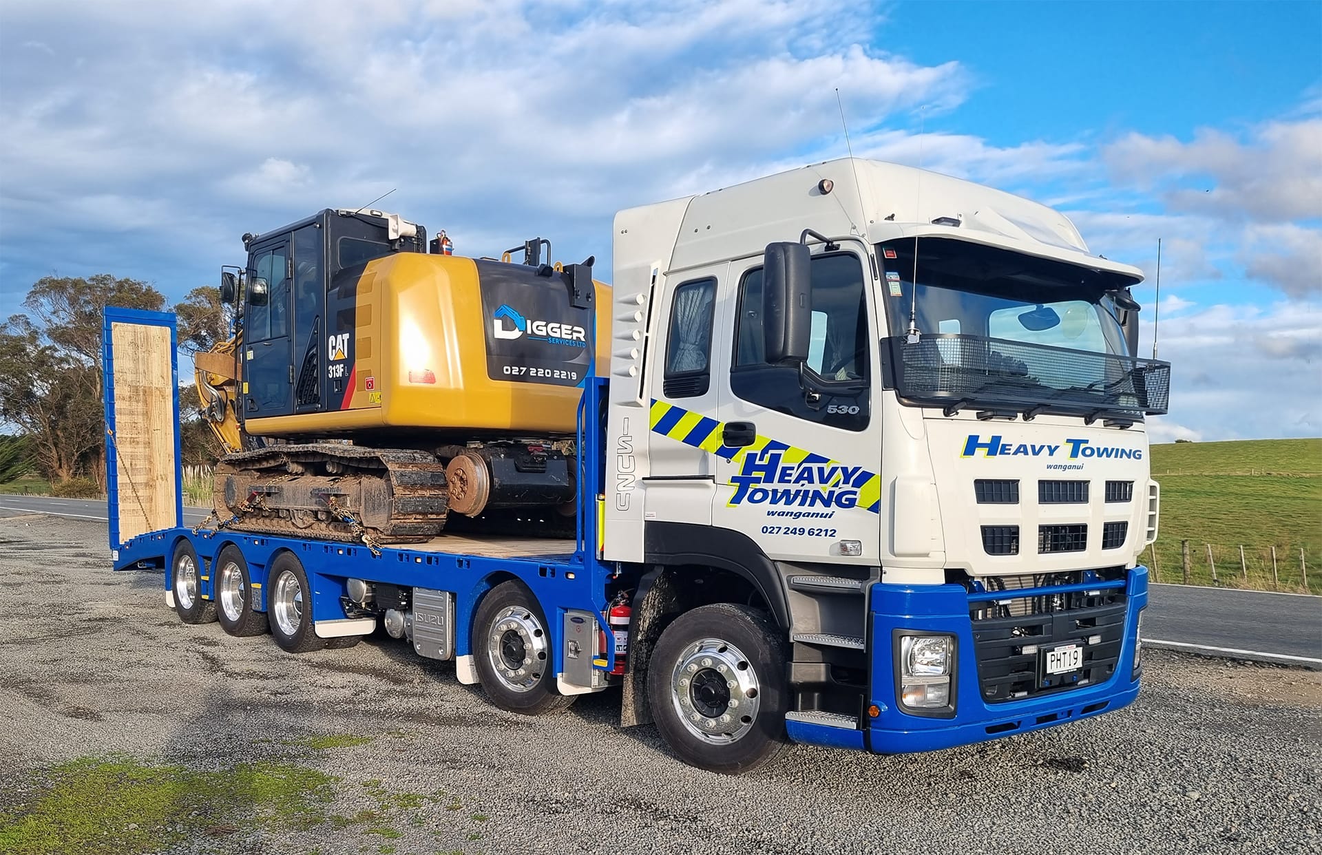Heavy Towing truck transporting a CAT excavator on a low-loader trailer